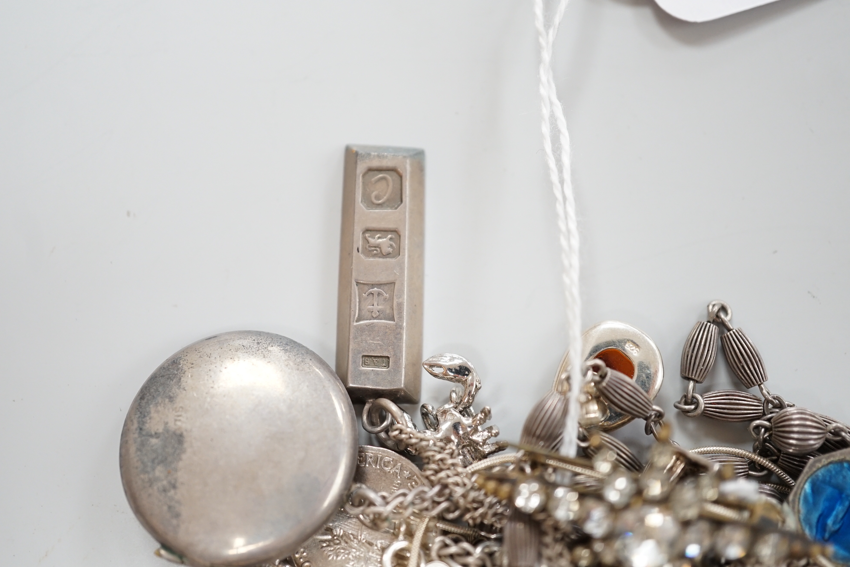 A silver charm bracelet and a small quantity of other silver and white metal jewellery.